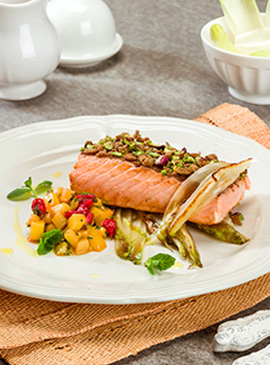 Salmon with a whole wheat bread and pistachios crust on a bed of grilled Belgian endive with diced kiwi, currant and mint