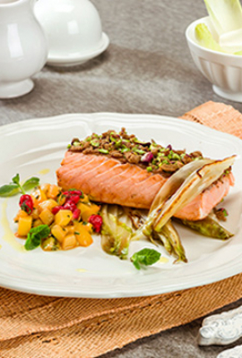 Salmon with a whole wheat bread and pistachios crust on a bed of grilled Belgian endive with diced kiwi, currant and mint